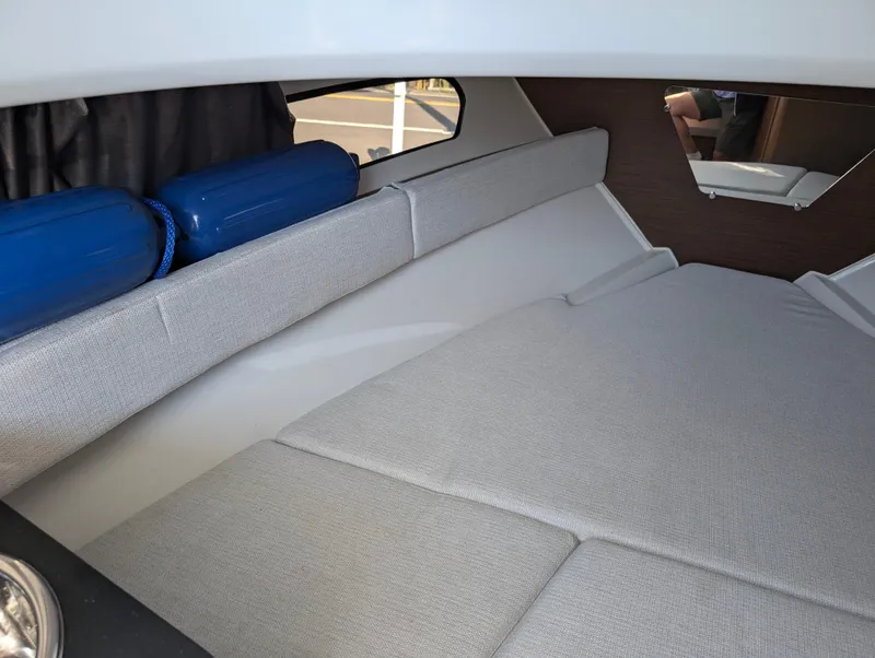 Slide: The Image of Interior cabin of 2022 Jeanneau Leader 7.5 WA S3 with gray seating and window view. - 24