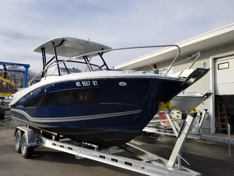 Slide: The Image of 2022 Jeanneau Leader 7.5 WA S3 boat on trailer, parked outdoors. - 4