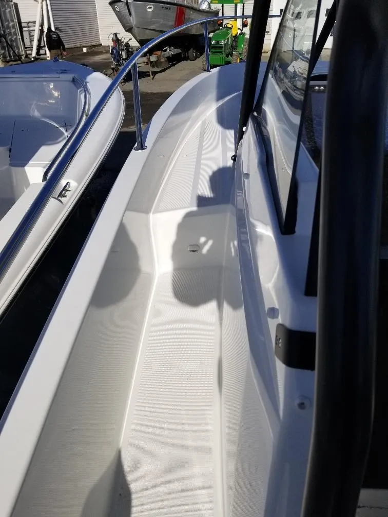 Slide: The Image of 2022 Jeanneau Leader 7.5 WA S3 boat deck with sleek design and railing. - 7