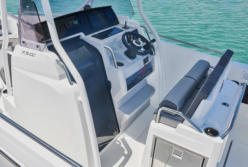 Slide: The Image of 2023 Jeanneau Leader 7.5CC S3 boat cockpit with steering wheel and seating. - 9