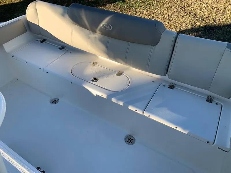 Slide: The Image of 2024 Key West 219 FS boat seating area with storage compartments. - 11