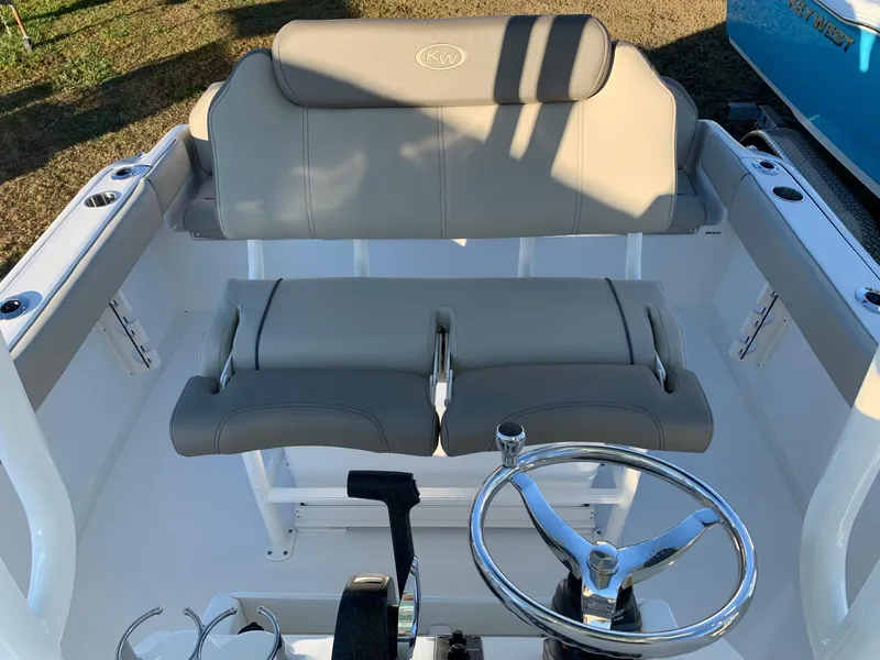 Slide: The Image of 2024 Key West 219 FS boat helm with dual seats and steering wheel. - 16