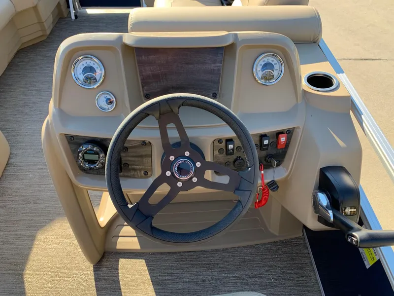 Slide: The Image of 2024 Starcraft LX22 R boat dashboard with steering wheel and control panel. - 10