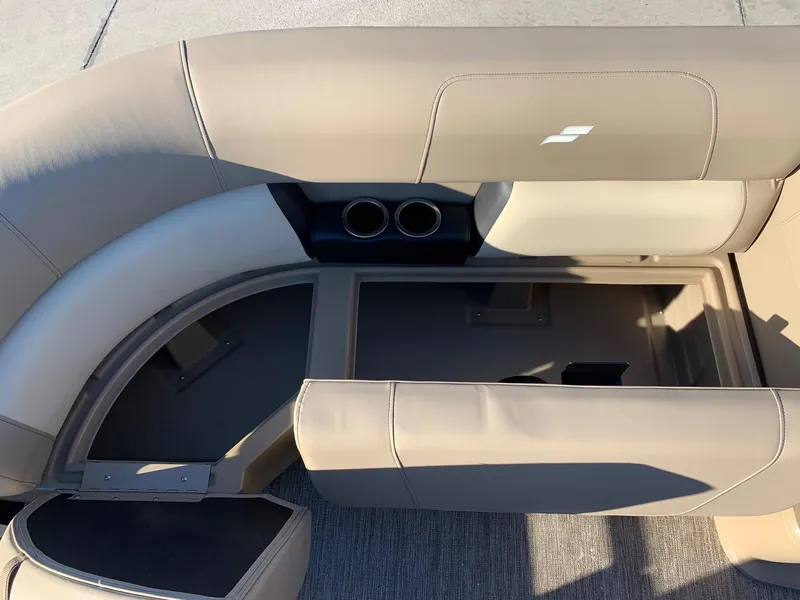 Slide: The Image of 2024 Starcraft LX22 R boat interior seating with storage compartment. - 12
