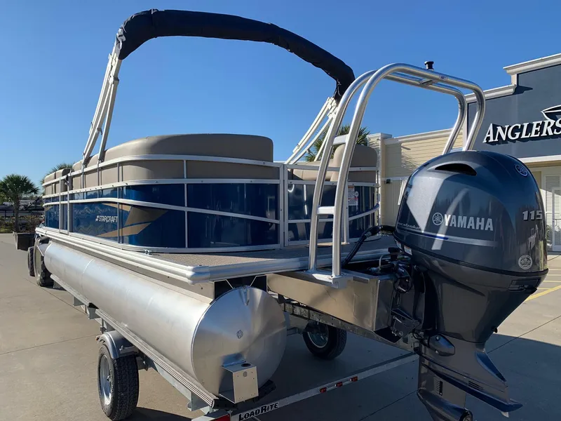 Slide: The Image of 2024 Starcraft LX22 R pontoon boat with Yamaha 175 engine on trailer. - 2