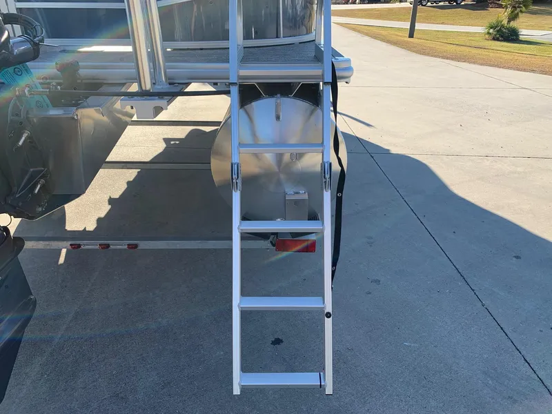 Slide: The Image of 2024 Starcraft LX22 R boat with rear ladder on concrete surface. - 4