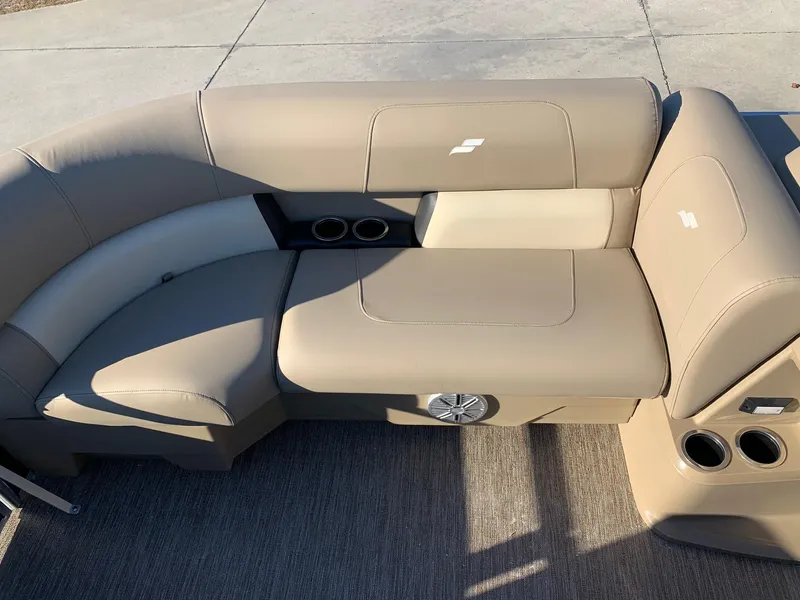 Slide: The Image of 2024 Starcraft LX22 R boat seating with beige upholstery and cup holders. - 13