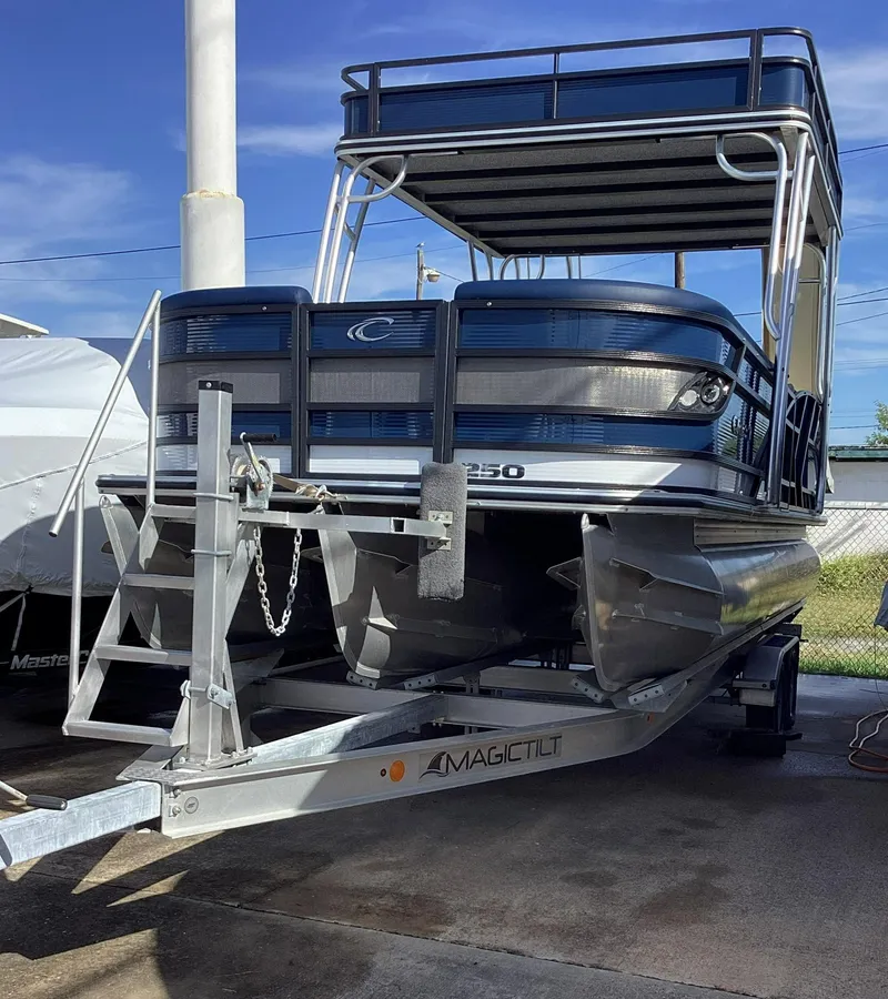 The Image of 2022 Crest CARIBBEAN LX 250 L pontoon boat on a trailer. - 0