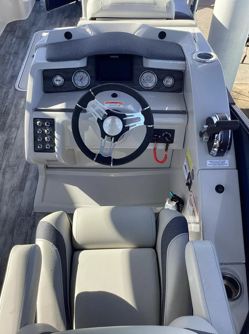 Slide: The Image of 2022 Crest CARIBBEAN LX 250 L boat dashboard with steering wheel and control panel. - 13