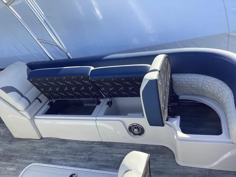 Slide: The Image of 2022 Crest CARIBBEAN LX 250 L boat interior seating and storage compartments. - 18