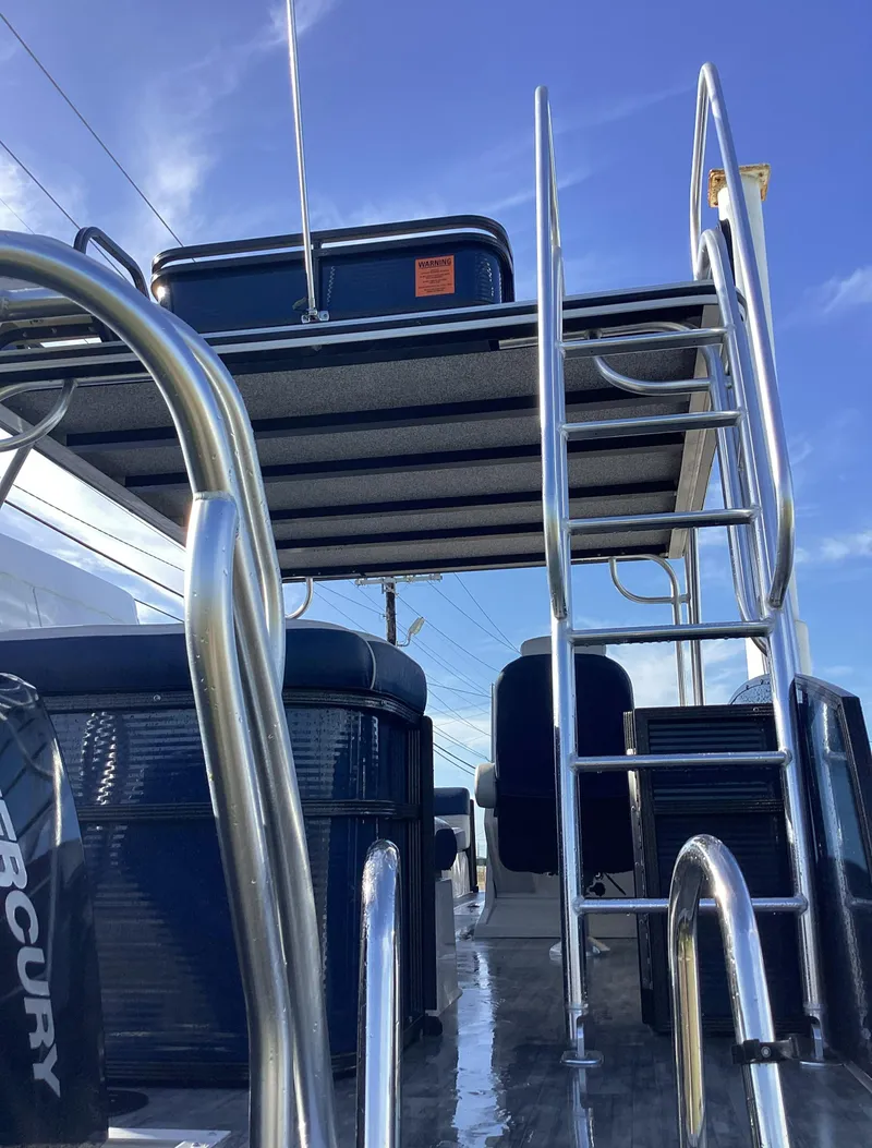 Slide: The Image of 2022 Crest CARIBBEAN LX 250 L pontoon boat with upper deck and ladder. - 2