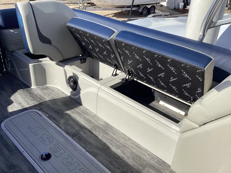 Slide: The Image of 2022 Crest CARIBBEAN LX 250 L boat interior with open storage compartments. - 20