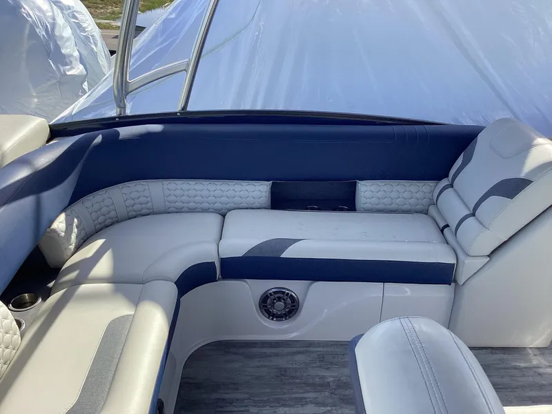 Slide: The Image of 2022 Crest CARIBBEAN LX 250 L boat interior with white and blue seating. - 21