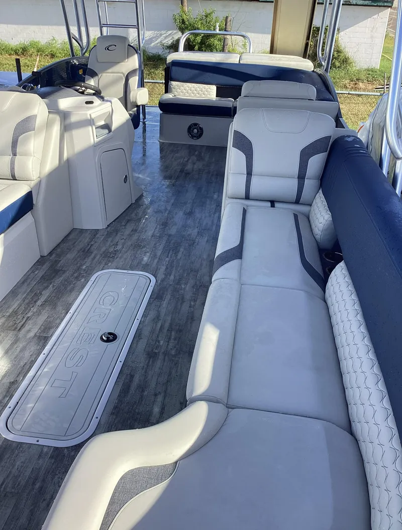 Slide: The Image of 2022 Crest CARIBBEAN LX 250 L pontoon boat interior with spacious seating and modern design. - 23