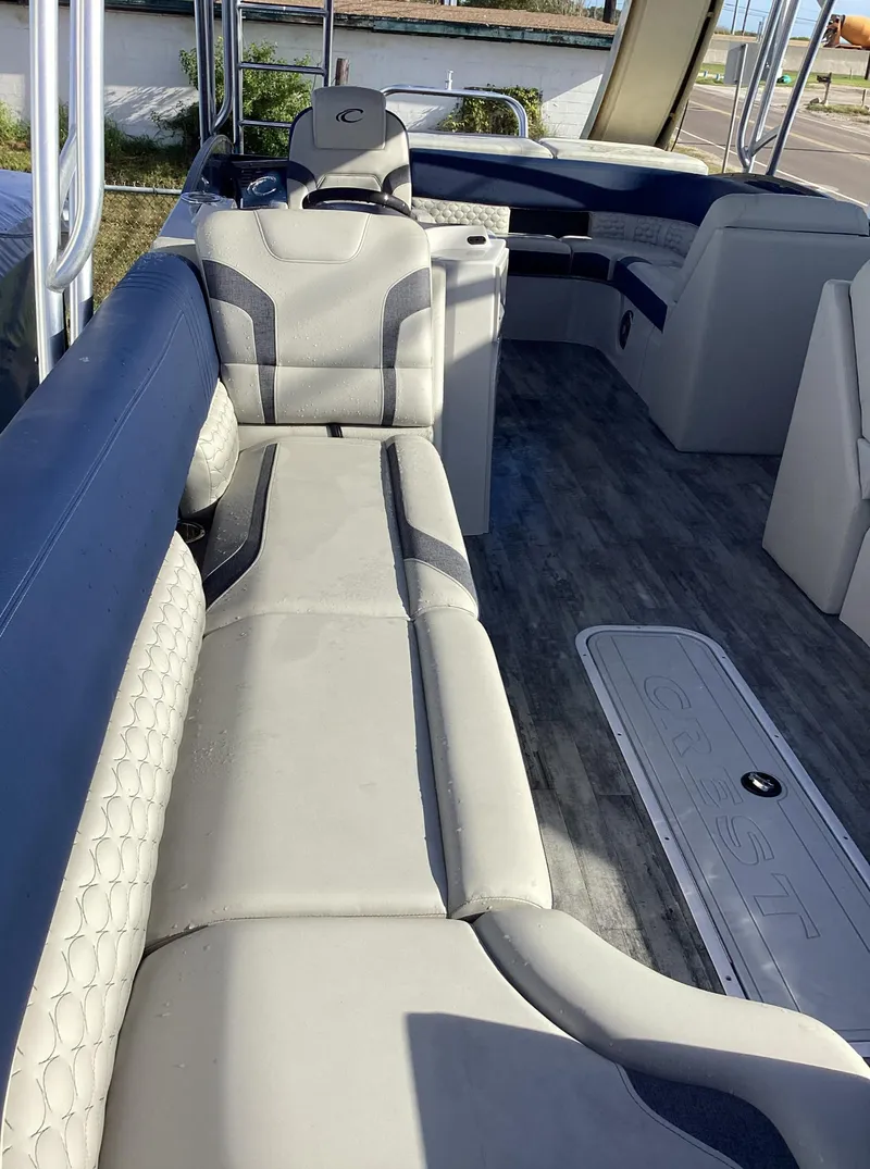 Slide: The Image of 2022 Crest CARIBBEAN LX 250 L pontoon boat interior with luxurious seating. - 24
