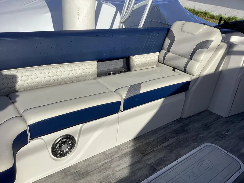 Slide: The Image of 2022 Crest CARIBBEAN LX 250 L boat interior with blue and white seating. - 25