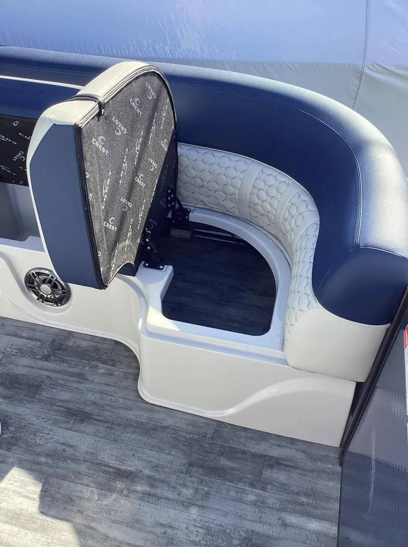 Slide: The Image of 2022 Crest CARIBBEAN LX 250 L boat interior seating with storage compartment. - 26