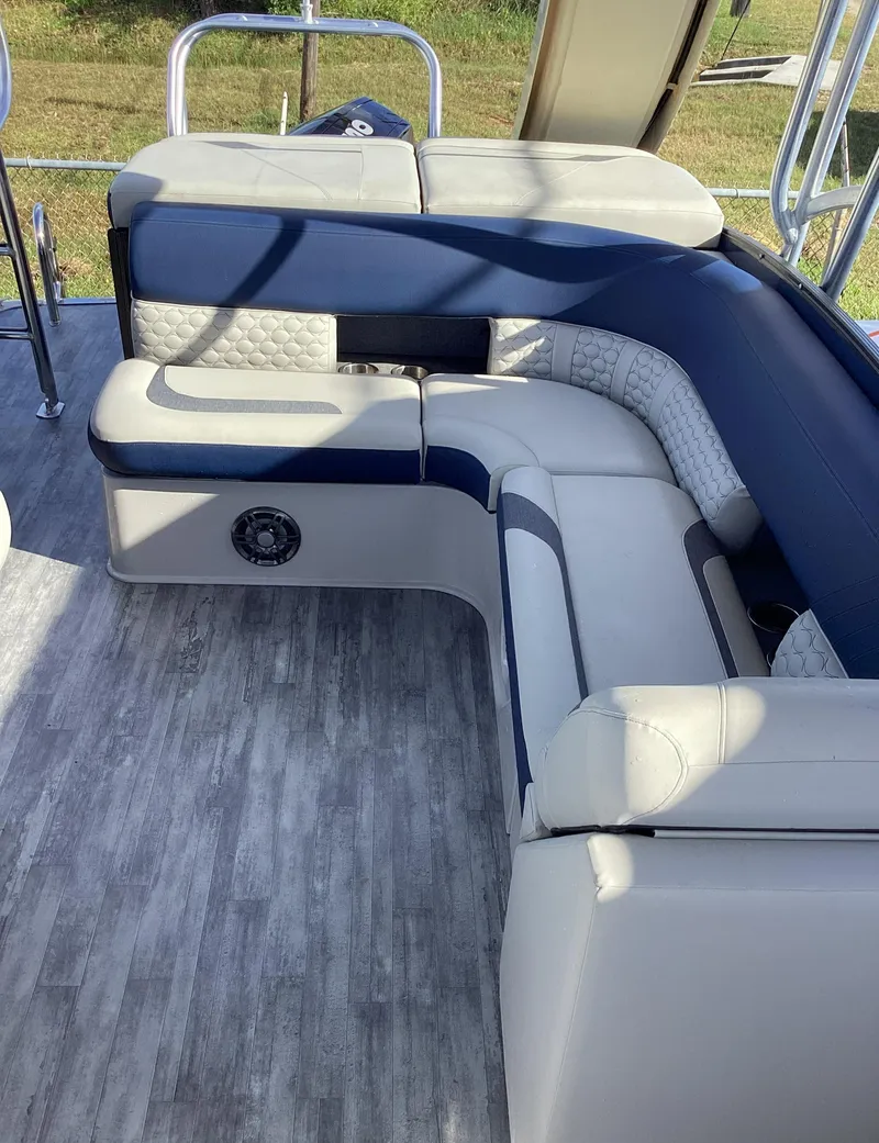 Slide: The Image of 2022 Crest CARIBBEAN LX 250 L boat interior with cushioned seating and modern flooring. - 27