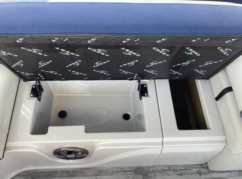 Slide: The Image of Open storage compartment in 2022 Crest CARIBBEAN LX 250 L boat. - 28