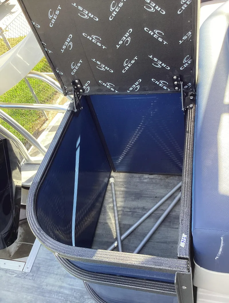 Slide: The Image of Open storage compartment on a 2022 Crest CARIBBEAN LX 250 L boat. - 29