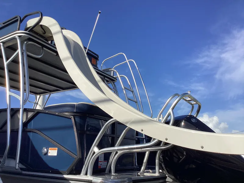 Slide: The Image of 2022 Crest CARIBBEAN LX 250 L boat with slide against blue sky. - 4