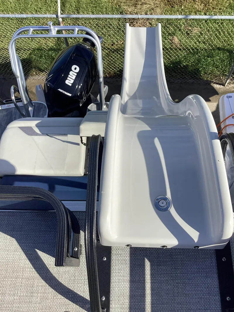 Slide: The Image of 2022 Crest CARIBBEAN LX 250 L pontoon boat with slide and outboard motor. - 7