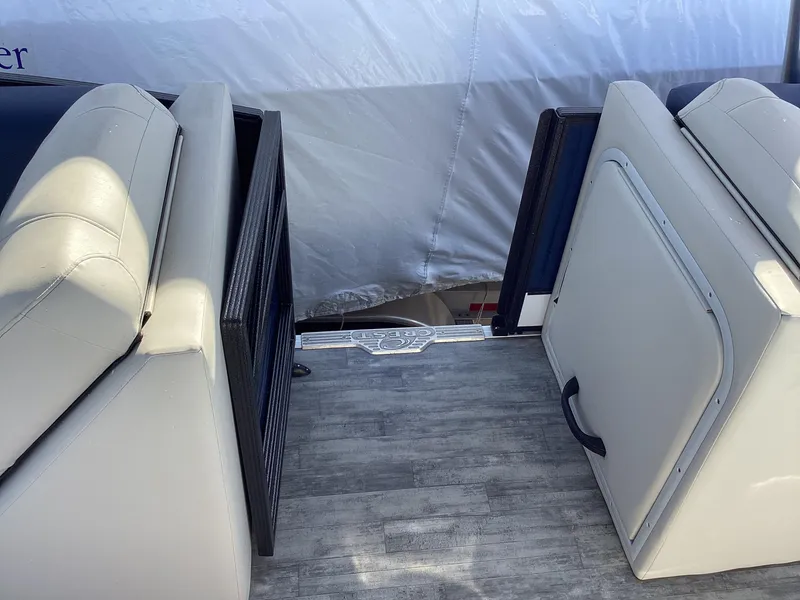 Slide: The Image of 2022 Crest CARIBBEAN LX 250 L boat interior with seating and storage compartments. - 9