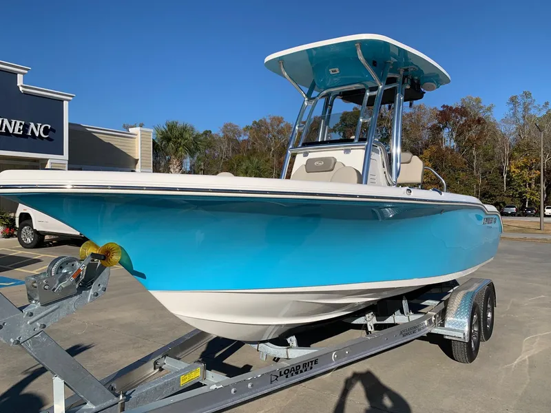 Slide: The Image of 2024 Key West 219 FS boat on trailer, blue hull, parked outdoors. - 1