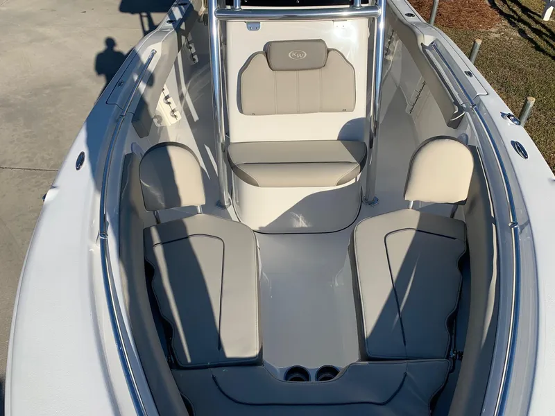 Slide: The Image of 2024 Key West 219 FS boat interior with cushioned seating and storage compartments. - 14