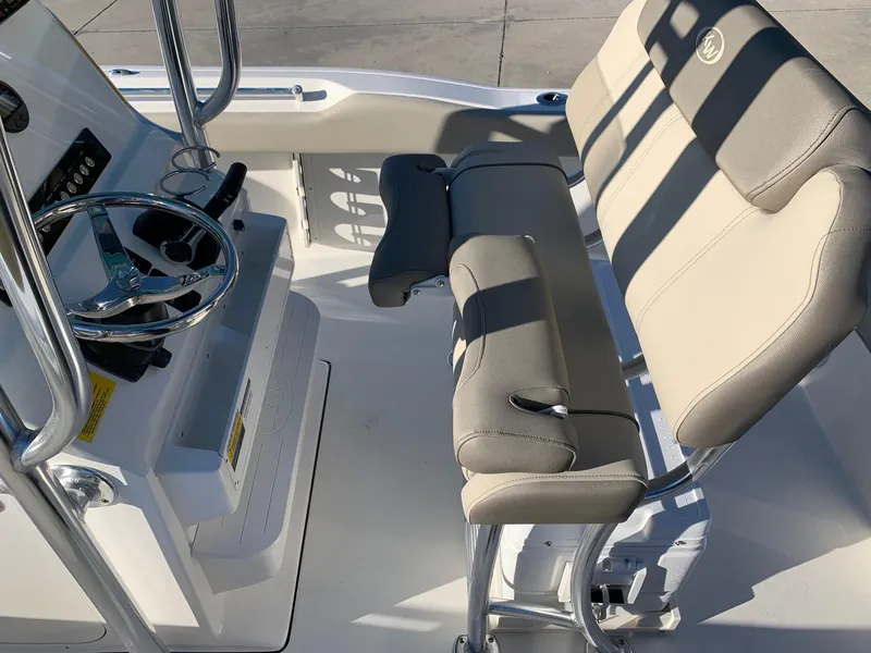 Slide: The Image of 2024 Key West 219 FS boat interior with steering wheel and cushioned seating. - 4
