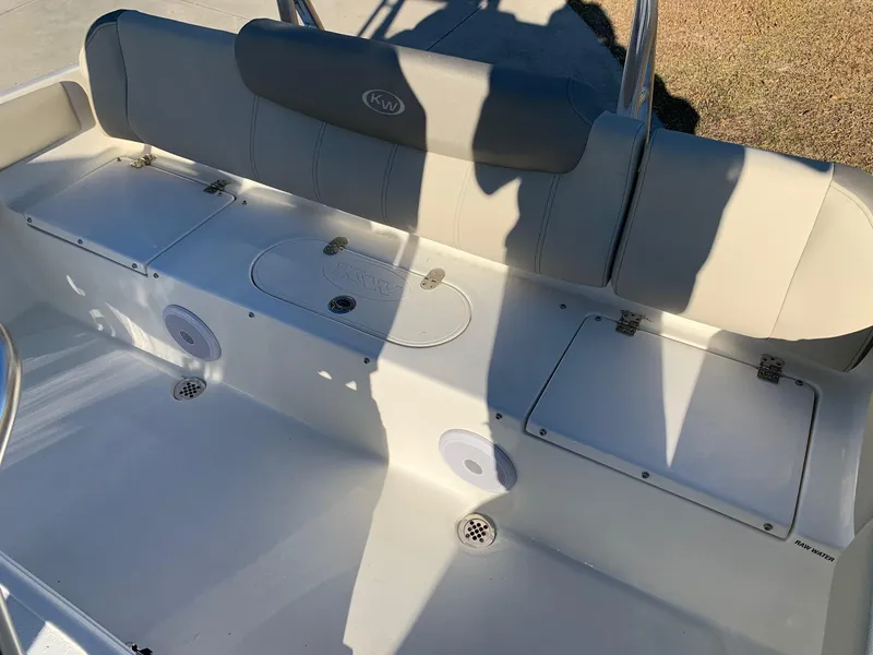 Slide: The Image of 2024 Key West 219 FS boat interior seating and storage compartments. - 7