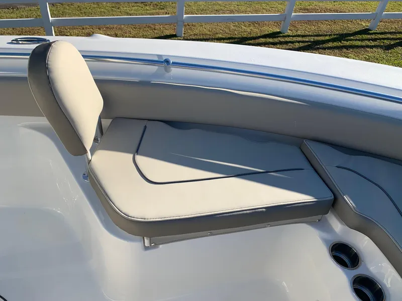 Slide: The Image of 2024 Key West 219 FS boat with cushioned seating and cup holders. - 15