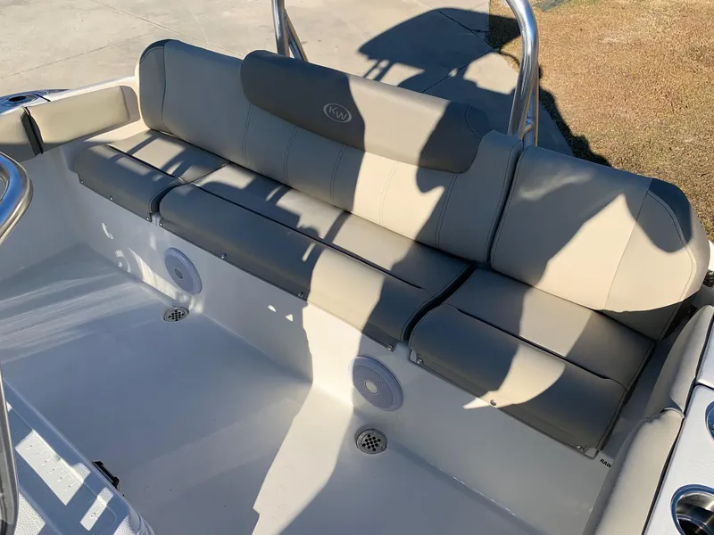 Slide: The Image of 2024 Key West 219 FS boat with cushioned seating and built-in speakers. - 6