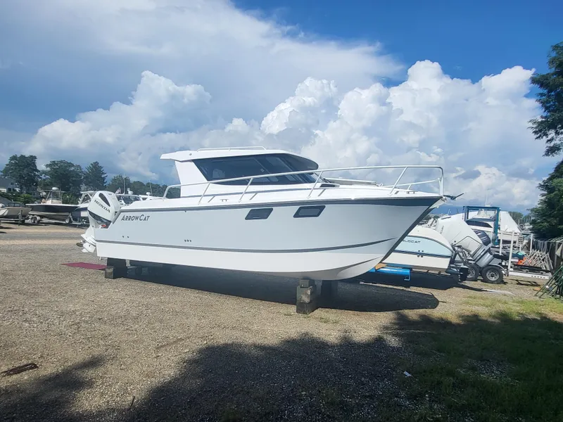 The Image of 2024 ArrowCat 320 boat on land with a cloudy sky background. - 0