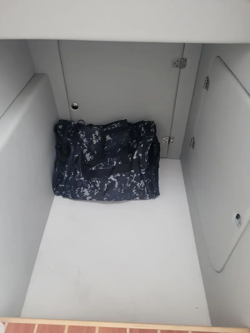 Slide: The Image of 2024 ArrowCat 320 storage compartment with a camouflage bag inside. - 10