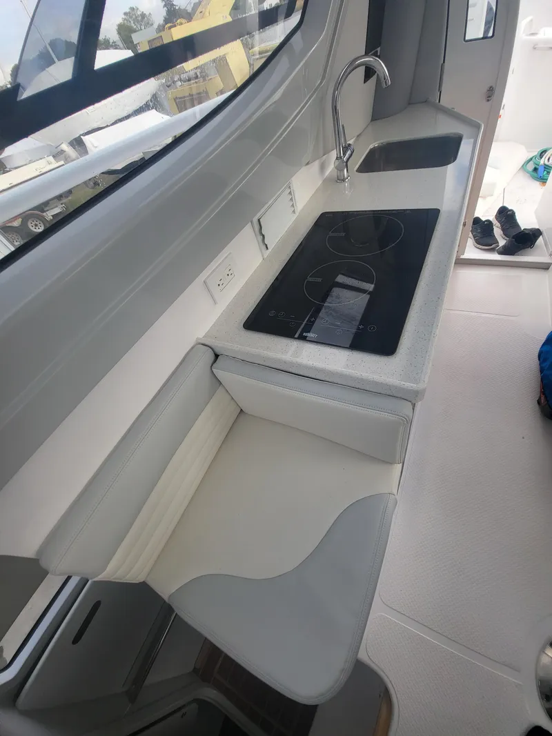 Slide: The Image of 2024 ArrowCat 320 boat interior kitchen with stove and sink. - 3
