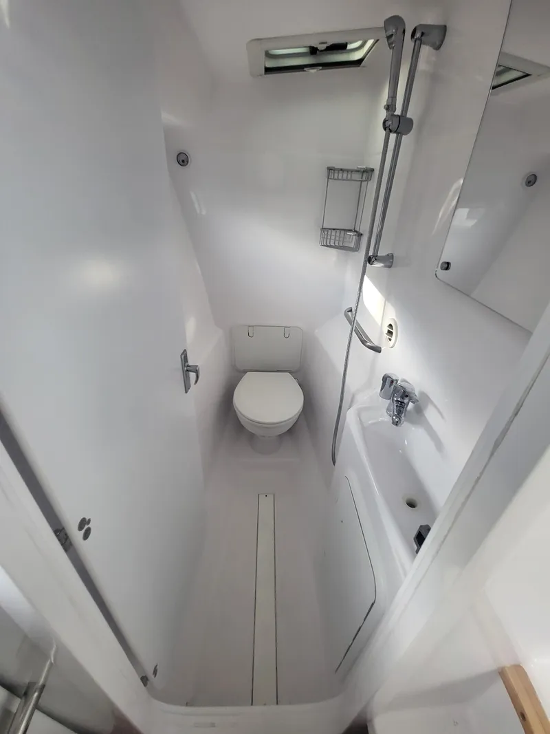 Slide: The Image of 2024 ArrowCat 320 boat bathroom with shower, toilet, and sink. - 9