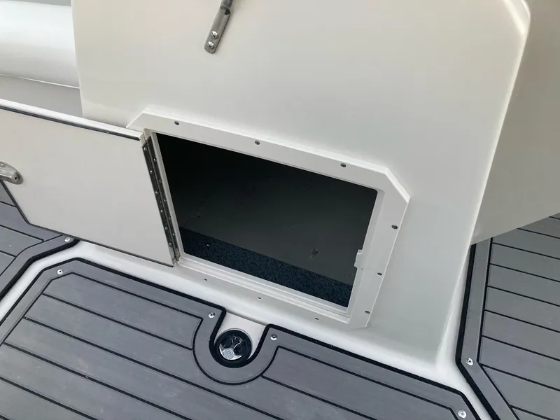 Slide: The Image of 2024 Starcraft SVX 210 boat storage compartment with open door. - 15