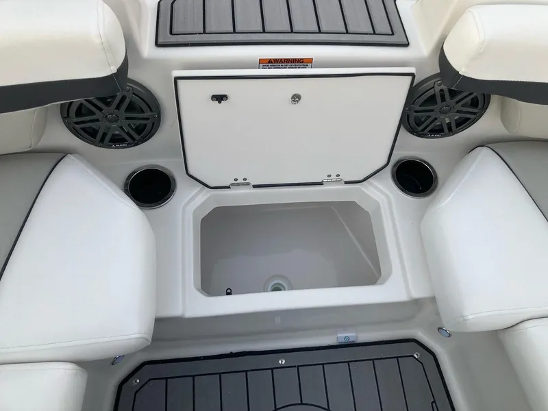 Slide: The Image of 2024 Starcraft SVX 210 boat interior with storage compartment and cup holders. - 17