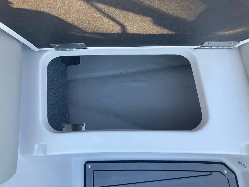 Slide: The Image of Open storage compartment in 2024 Starcraft SVX 210 boat. - 19