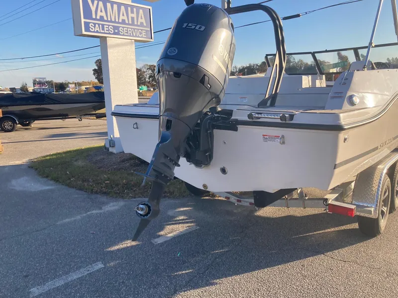Slide: The Image of 2024 Starcraft SVX 210 boat with Yamaha 150 outboard motor at dealership. - 3