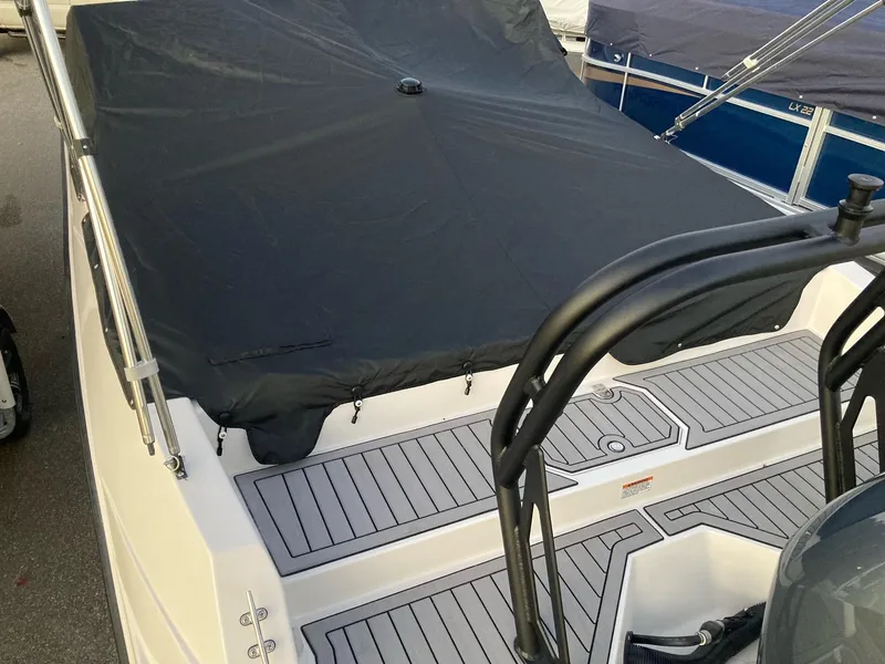 Slide: The Image of 2024 Starcraft SVX 210 boat with covered deck and sleek design. - 5