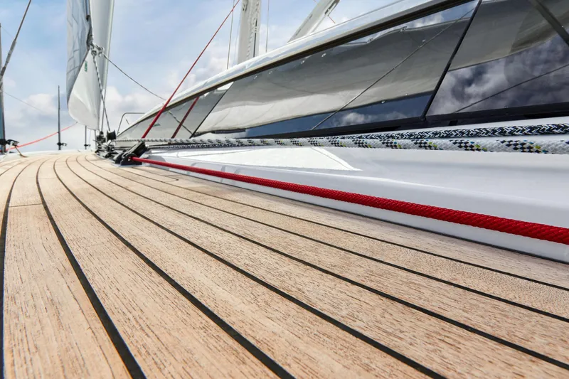 Slide: The Image of Close-up of the teak deck on a 2025 Dehler 38 SQ sailboat. - 5