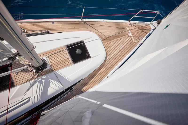 Slide: The Image of 2025 Dehler 38 SQ sailboat deck with wooden finish and white sails. - 6