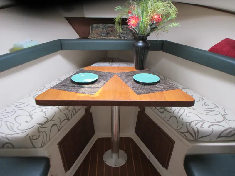 Slide: The Image of Mainship 30 PILOT 2000 boat interior with dining table and cushioned seating. - 14