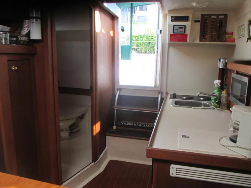 Slide: The Image of 2000 Mainship 30 PILOT interior with kitchenette and bathroom. - 19