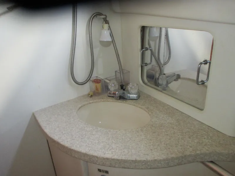 Slide: The Image of 2000 Mainship 30 PILOT bathroom sink with mirror and countertop. - 21