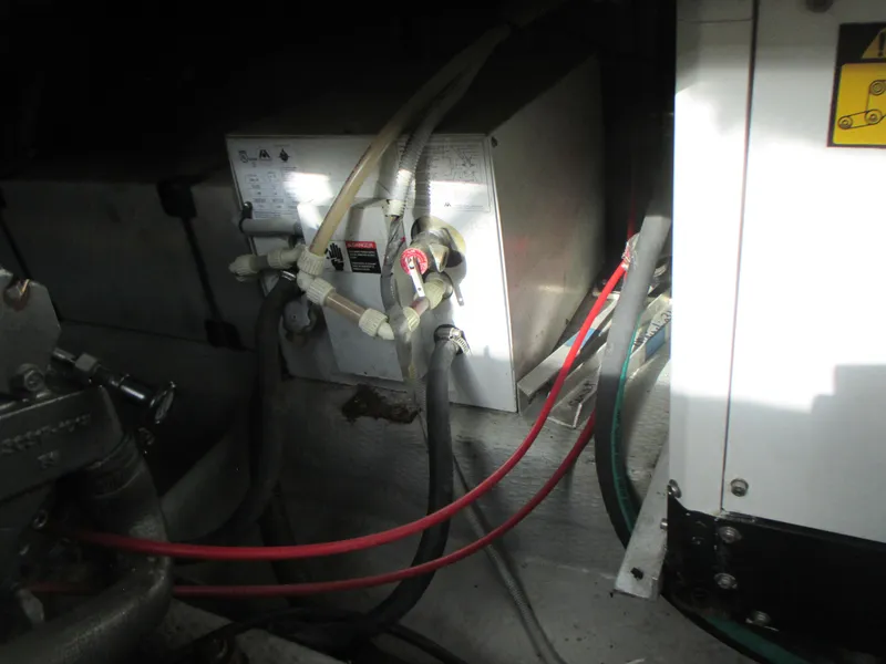 Slide: The Image of Engine compartment of a 2000 Mainship 30 PILOT boat with wiring and components. - 25