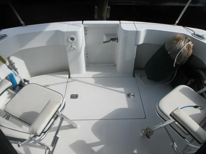 Slide: The Image of Cockpit of a 2000 Mainship 30 PILOT boat with seating and storage. - 7