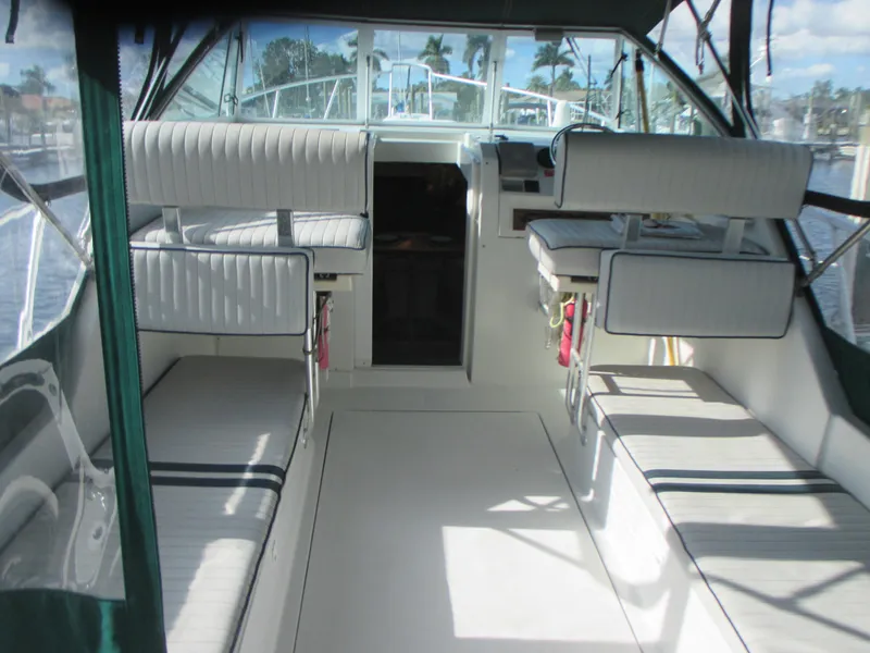 Slide: The Image of 2000 Mainship 30 PILOT boat interior with seating and helm station. - 8